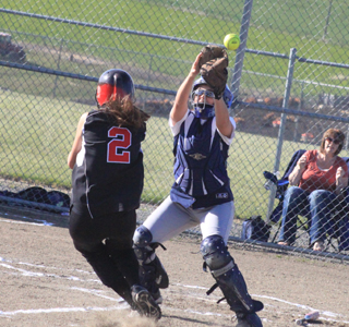 Savanah Prigge hits the dirt and was able to slide in under the tag and score on this play.