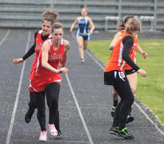 Shelby VonBargen hands a lead over to MaKayla Schaeffer for the final leg of the 4x400 which Prairie won.