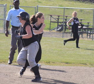 Tanna Schlader tags the runner and looks to complete a double play against Highland. In the background is Kelsey Tidwell.