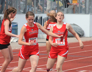 Claire Whitley takes a quick step back to the middle of her lane after taking the baton from Keely Schmidt in the 4x400 final. She nearly stepped out of her lane which would have DQs the team. Also of note she was running even with the other teams around the first curve but suddenly broke in front by about 5 yards once she hit the straightaway.