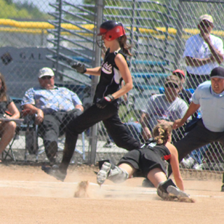 Savanah Prigge scores ahead of a diving tag attempt by Greenleafs catcher as she completes her inside the park homer, part of an 11-run first inning.