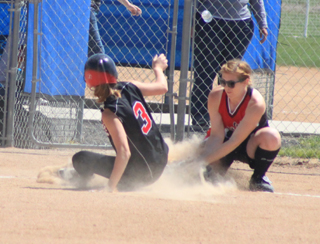 Tanna Schlader just beats the throw at first for a triple in the championship game against Greenleaf.