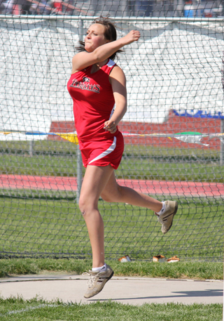 Taylor Heitman tosses the discus at state. She finished 4th in the event. Photo by Michelle Schaeffer.