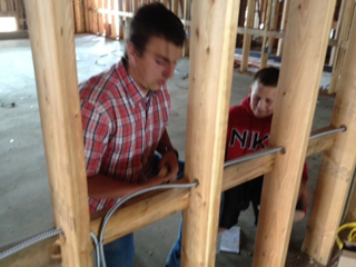 Dakota Wilson (Idaho Leads participant) and Ryan Glimp pulling wire to the outlet boxes.