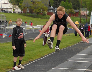 Jake Bruner triple jumping at a junior high meet.