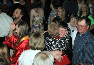 Robert Nau gets a congratulatory hug as his parents look on.