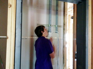 Westin Crenshaw is managing the wiring in the data closet.