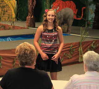 Haley Danly smiles for the judges Monday morning during the Making the Most of Me, Level II judging.