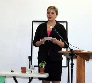 Whitney Sonnen gives her speech at the Royalty Luncheon demonstrating she grew in 4-H much like a seed grows into a plant when nurtured.