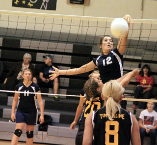 Megan Seubert makes a block at the net during one of Summits matches at the Highland Jamboree last Thursday. At left is Kaitlyn Stubbers.