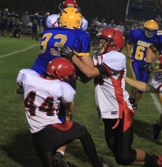 Kade Perrin and Isaiah Shears combine on a tackle of a Salmon River ballcarrier.