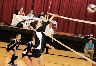 Leah Holthaus hits the ball against Lapwai as Cheryl Gehring and Tyler Workman watch.