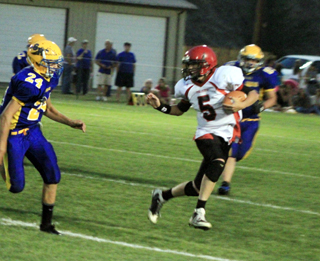 Marcus Higgins carries the ball.