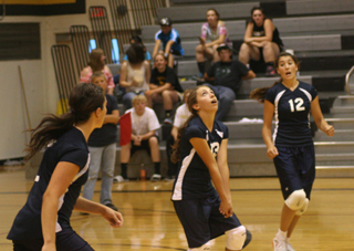 Rachel Waters, center, gets ready to make asset in Summits match against Nezperce. At left is Megan Rehder and at right is Megan Seubert. Photo by Steve Wherry.