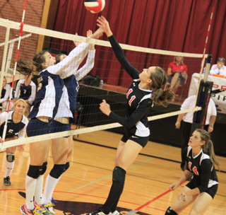 Krystin Uhlenkott tips the ball past Grangevilles blockers as Shelby VonBargen watches and was ready if the ball got blocked.