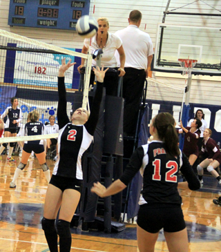 Hailey Danly sets the ball for Tyler Workman at the Grangeville Tournament in the first Deary match.