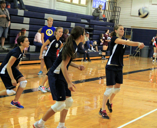 Julia Osborne makes a pass for Summit. Others from left are Megan Rehder, Sarah Chmelik and Megan Seubert.