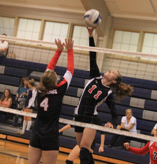 Krystin Uhlenkott goes high over a Deary block attempt in the championship match at Grangeville.