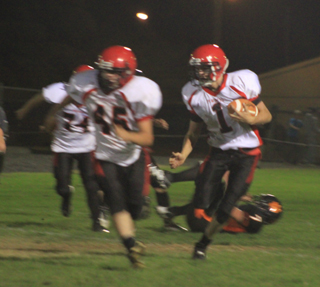 Lucas Arnzen, 1, used Garrett Schmidts lead block to break loose for big yardage on this play. In the back is Westin Crenshaw, 74.