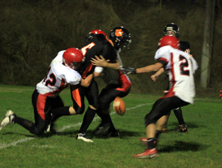 The ball came loose as Matthew Schwartz sacks the Kendrick quarterback on the last play of the first half. Will Weaver is at right.