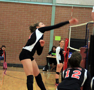 Krystin Uhlenkott goes for a kill against Asotin. #12 is Tyler Workman.