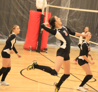 Leah Holthaus goes for the kill against Pomeroy at the Border Battle. Also shown from left are Tanna Schlader, Hailey Danly and Tyler Workman.