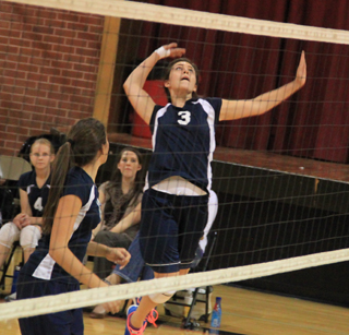 Megan Rehder winds up for a spike against Kendrick as Megan Seubert and the Summit bench watch.