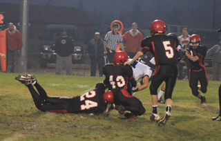 Jake Bruner and Jake Rowland combine on a tackle of Lapwai's Shelby Leighton. #5 is Marcus Higgins.