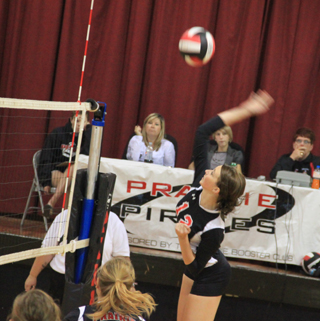 Tyler Workman is about to pound a spike over the net against Highland.
