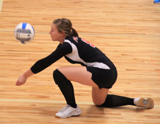 Brooke Schumacher goes to her knees to dig up a serve against Lapwai.