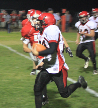 Calvin Hinkelman gains big yardage on a run late in the third quarter. At right is Matt Schwartz.