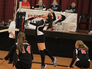 Cheryl Gehring goes up for a spike against C.V. on Senior Night as Shelby VonBargen and Kelsey Tidwell watch.
