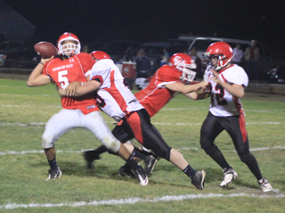 Garrett Schmidt tries to sack C.V.s quarterback before he can make the throw. At right is Matt Schwartz.