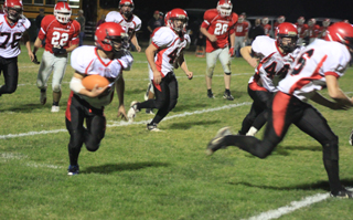 Hunter McWilliams follows lead blockers Seth Chaffee, 66, and Kade Perrin, 44, on what turned out to be the game-ending touchdown. Also shown are Frank Spencer, 76, and Garrett Schmidt.