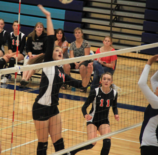 Shelby VonBargen reaches high for a spike against Lapwai as Krystin Uhlenkott watches.