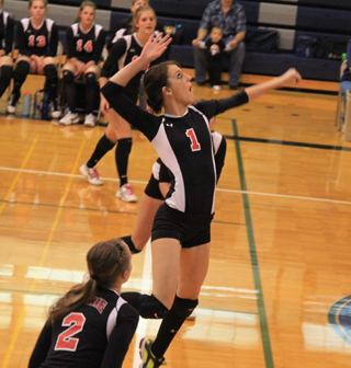 Leah Holthaus goes for a kill against Kamiah as Hailey Danly, foreground, and Tanna Schlader, background, watch. Hidden behind Holthaus is Tyler Workman.