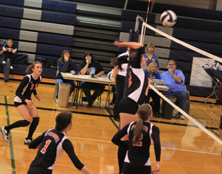 Tyler Workman played very well against Kamiah. Here she goes for one of her 14 kills. Shown from left are Krystin Uhlenkott, Leah Holthaus and Hailey Danly.