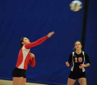 Stephanie Gimmeson hits the ball against Potlatch at District as Tanna Schlader watches.