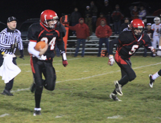 Jake Bruner went for 30 yards on this quarterback keeper. At right is Marcus Higgins.