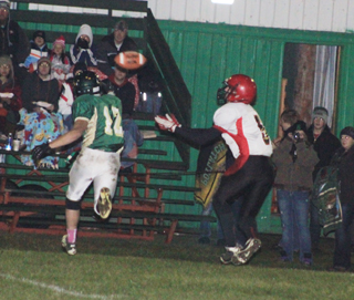 Marcus Higgins is about to catch a pass that he turned into an 80 yard scoring play and the games first touchdown.