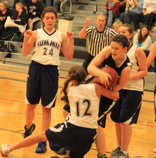 Megan Seubert battles a Highland player for a rebound. At left is Megan Rehder and at right is Rachael Frei.
