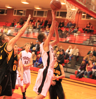 Dylon Bruegeman scores on a lay-up against Highland. Also shown is Tanner Ross.