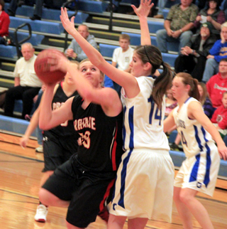 Kendall Schumacher powers up a shot at Genesee. Partially hidden is Keely Schmidt.