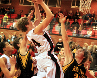Lucas Arnzen shoots against for 2 of his 22 points against Highland. At left is Tyler Hankerson.