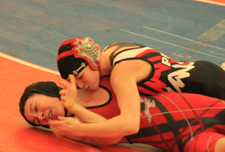 Kellie Heitman scores a near fall in her match against a Wallace wrestler at the Potlatch Tournament.