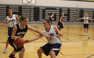 Rachael Frei guards the ball in the Deary game. At left is Megan Seubert and at right is Abi Chmelik. Photo by Rose Frei.