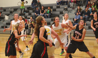 Prairie looks to grab a rebound against Highland. From left are Callie Mader, Tanna Schlader, Shelby VonBargen and Brooke Schumacher. Photo by Steve Wherry.