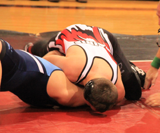 Garrett Schmidt is about to score a pin against a Grangeville wrestler.