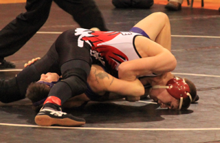 Kade Perrin scores a near fall during the home wrestling match last Tuesday, Dec. 18.