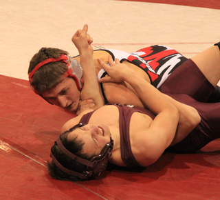 Tayler Heitman tries to pin a Kamiah wrestler during the home meet last Tuesday.